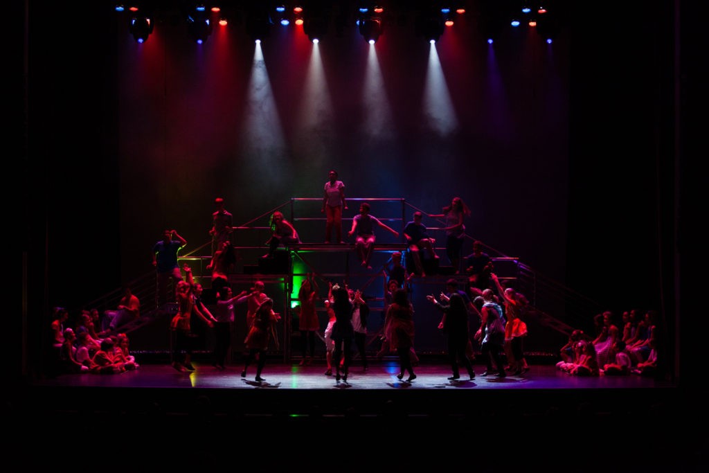 Joseph and the Amazing Technicolor Dreamcoat - kids in dark stage lighting