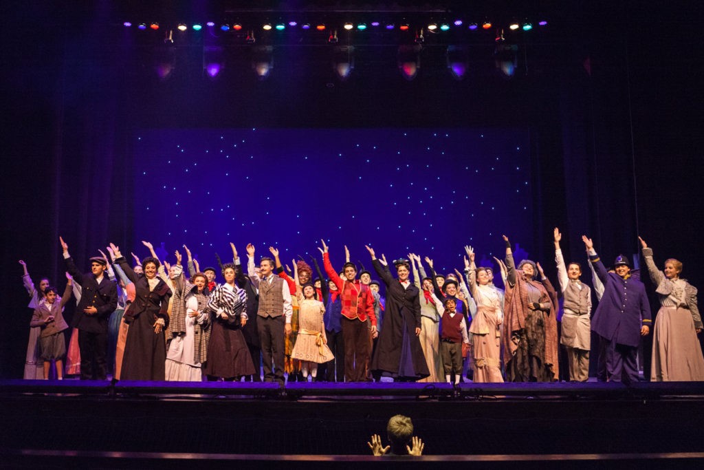 Mary Poppins - group shot singing with hands up