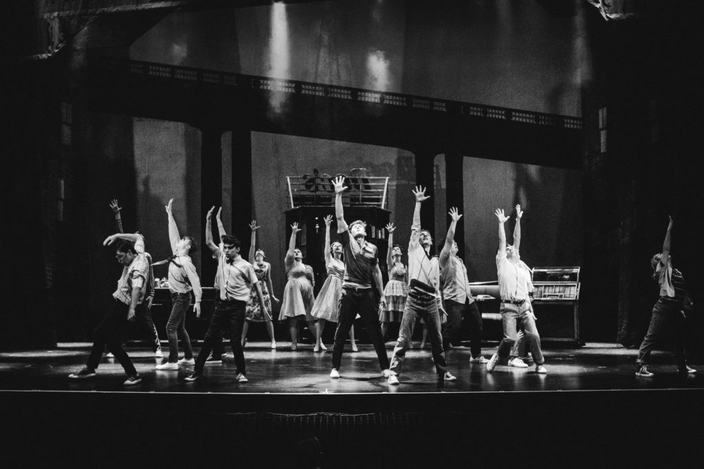 West Side Story - black and white group shot hands up