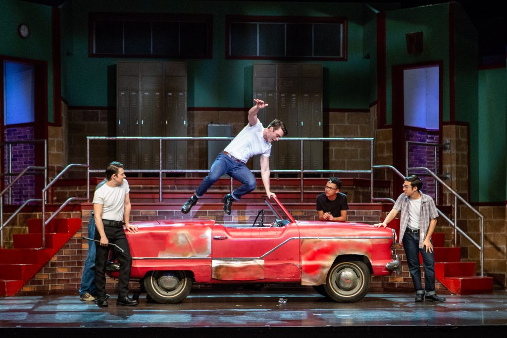 boys performing on prop car