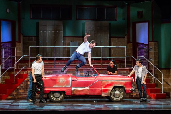 boys performing on prop car