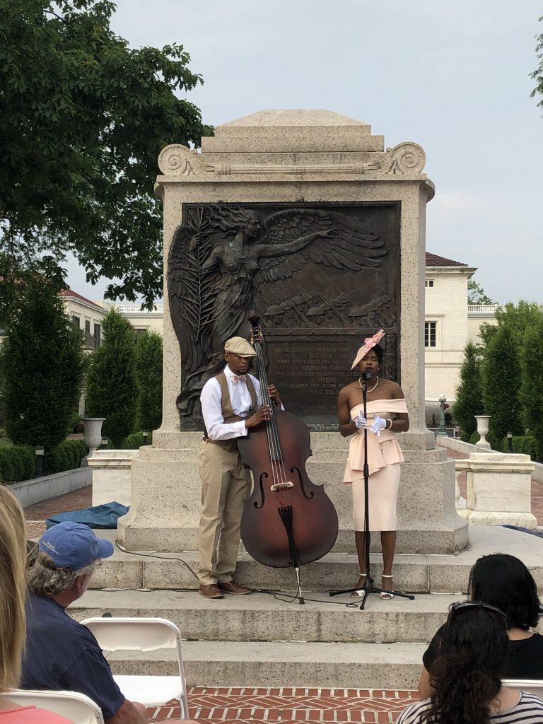 Acute Inflections outdoor concert, woman singing and man playing cello