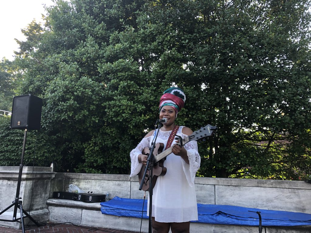 Tshila playing guitar outdoors