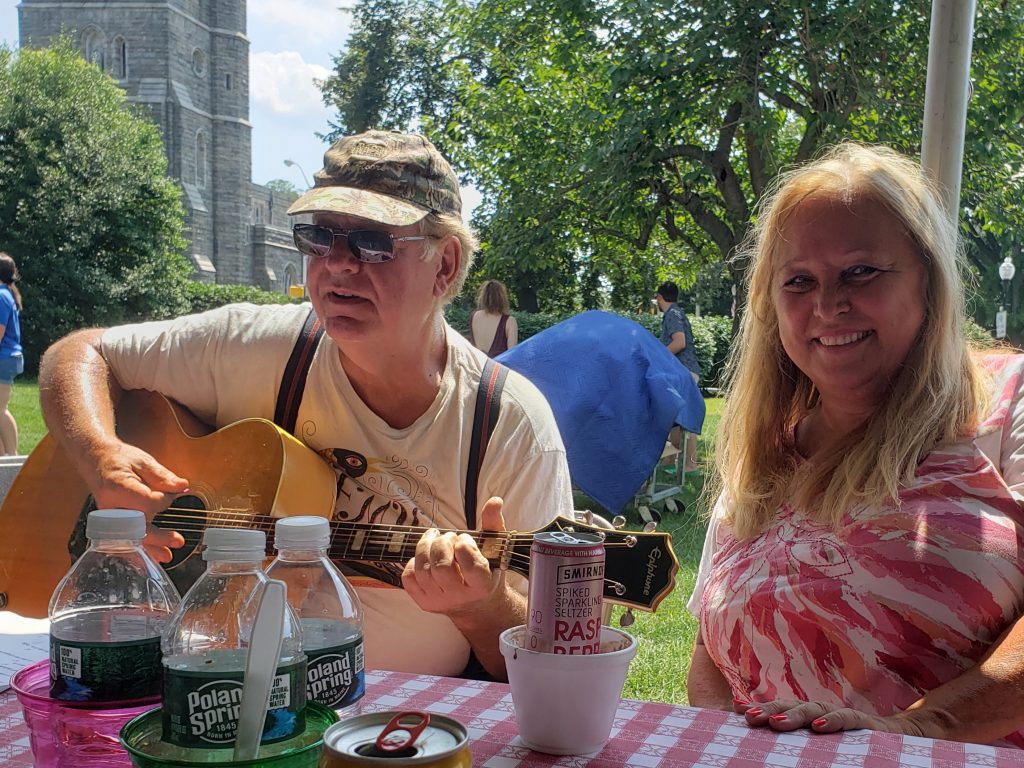 volunteers playing guitar at picnic