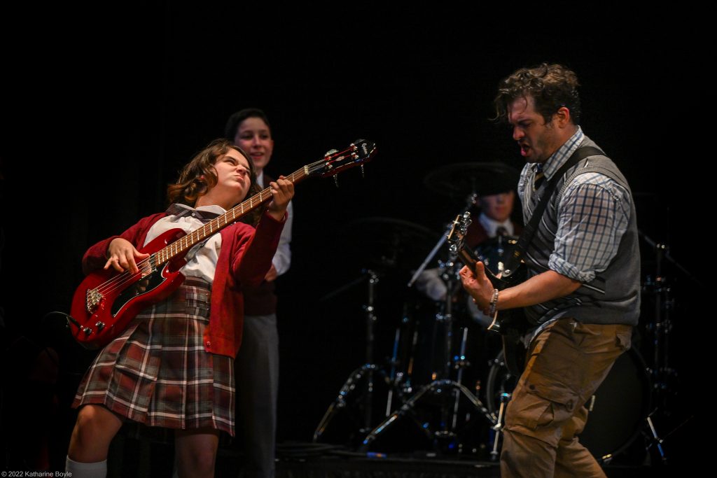 kids and mr jon playing guitar on stage