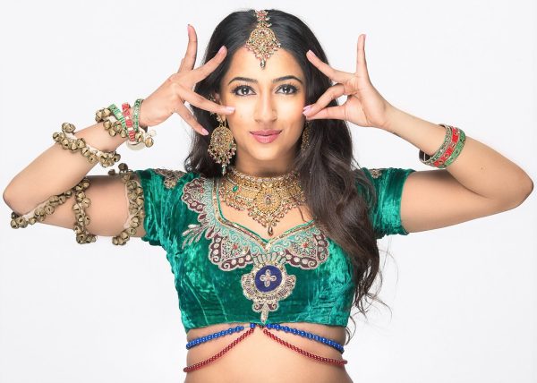 girl posnig hands in traditional indian garb