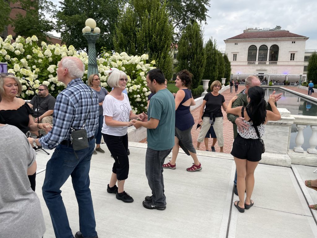 couples of all ages dancing at salsa under the stars