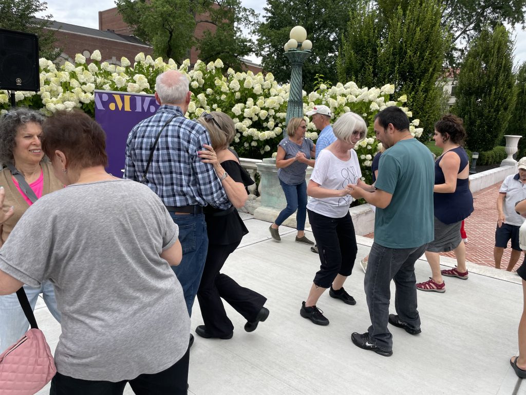 couples of all ages dancing at salsa under the stars