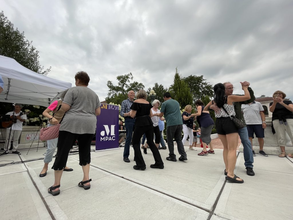 couples of all ages dancing at salsa under the stars