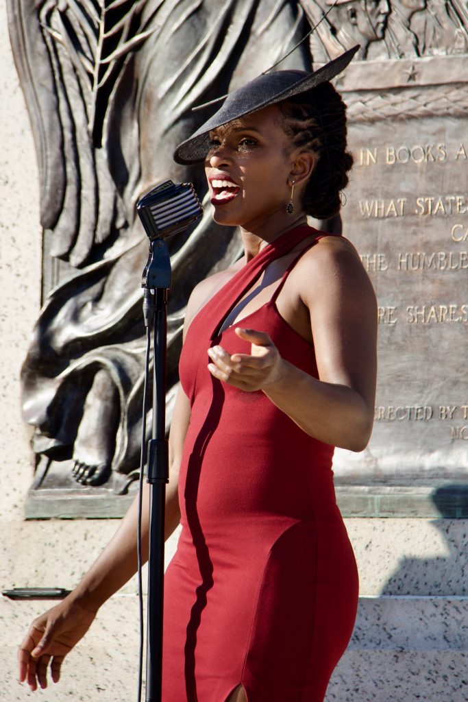 acute inflections, woman in red dress singing