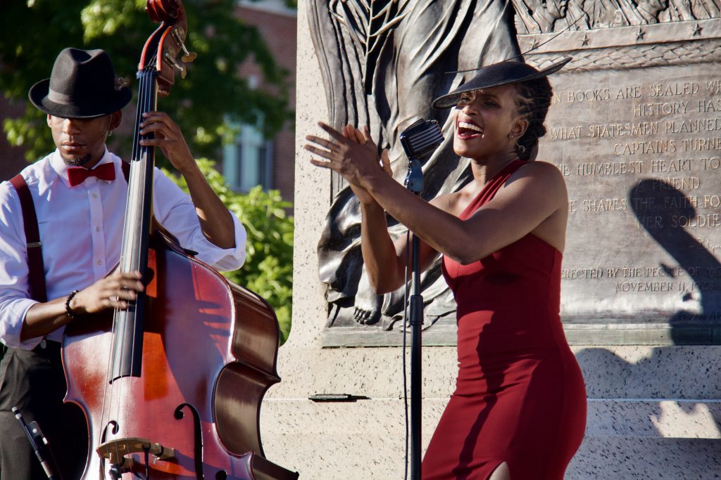 acute inflections, woman in red dress singing