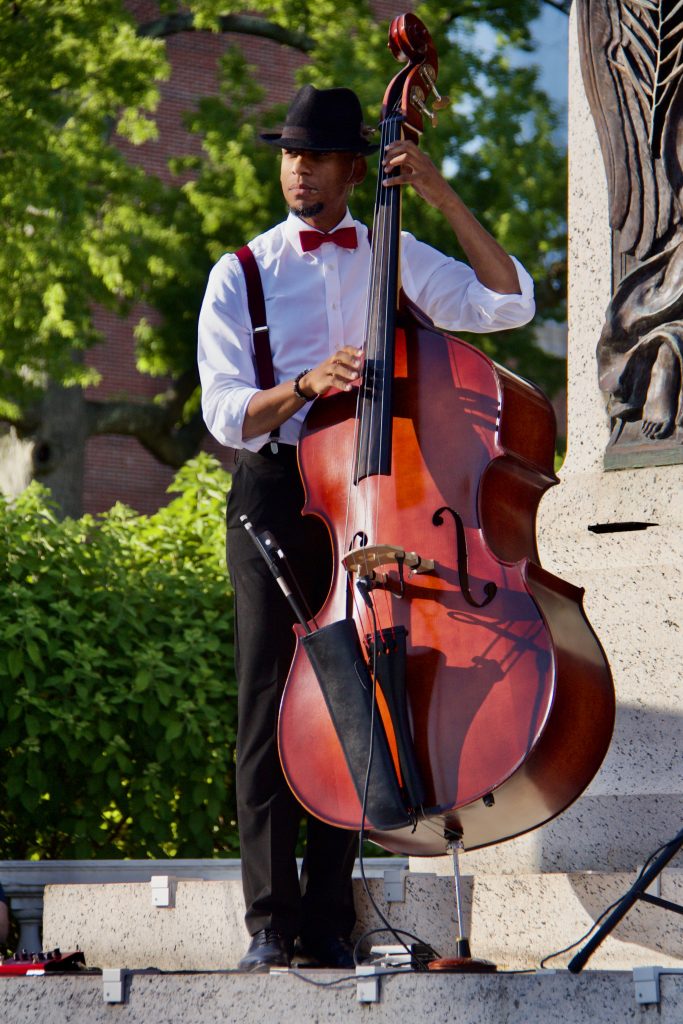 acute inflections, man in button down and suspenders playing cello