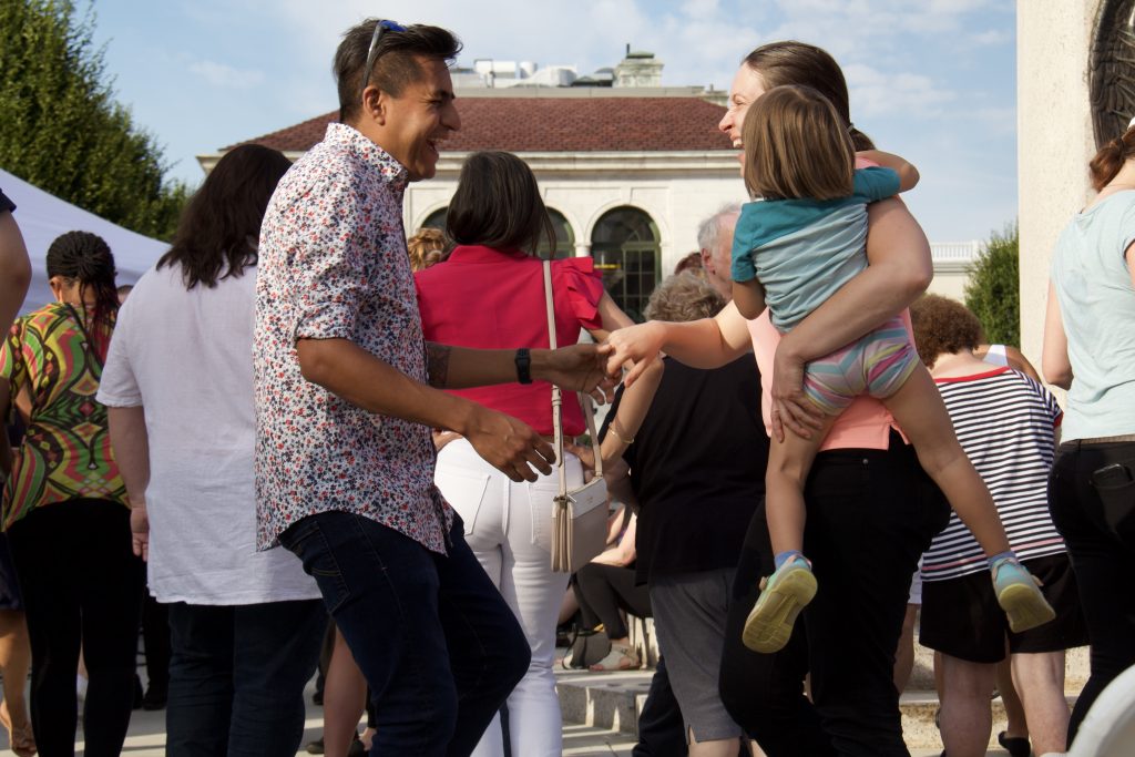 couple dancing with mom holding baby at salsa under the stars