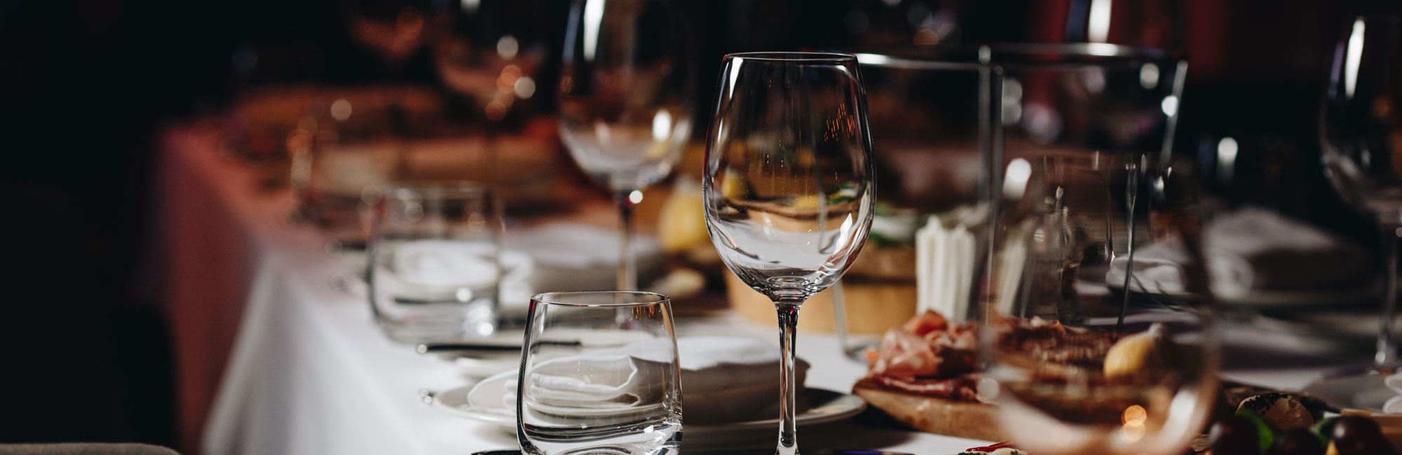 Dining table set with glassware and appetizers